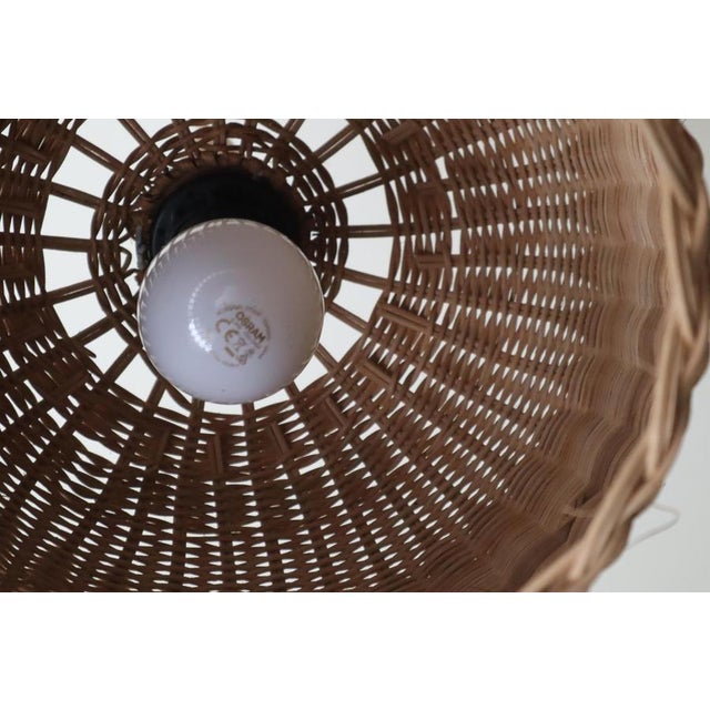 This lovely, handcrafted rattan lamp is sure to captivate you with its hand-woven lampshade and conical finial, likely...