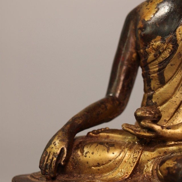 This impressive, heavy cast metal statue features Shakyamuni Buddha in the traditional "Earth-touching" mudra...