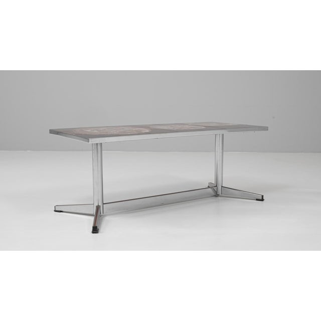 This 20th Century French chrome coffee table with ceramic top by Juliette Belarti exemplifies mid-century artistry and...
