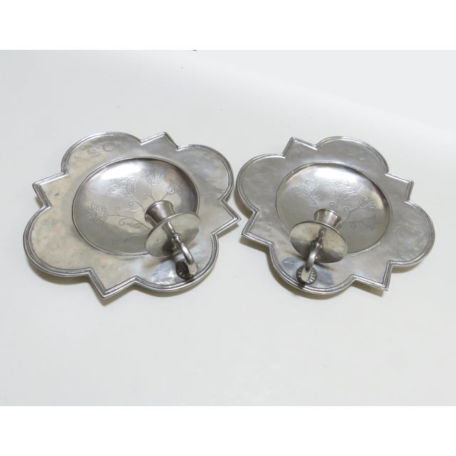 A pair of quatrefoil polished pewter wall sconces by Match. About Match: When David Reiss - a graduate of the Rhode Island...
