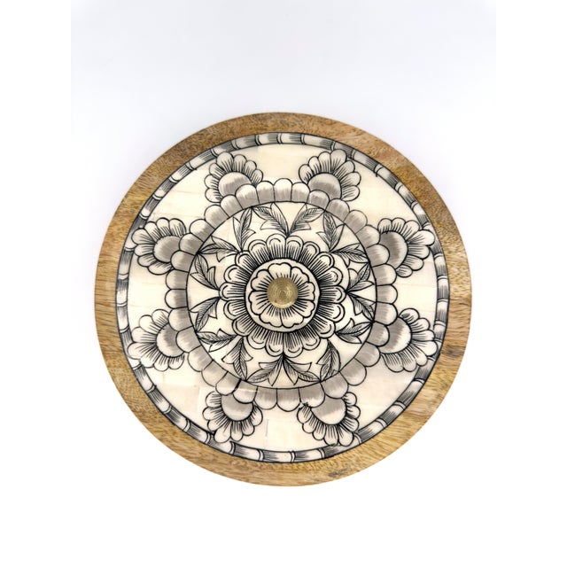 Handcrafted in India. A beautifully round storage box made from solid mango wood and topped with a delicately detailed...