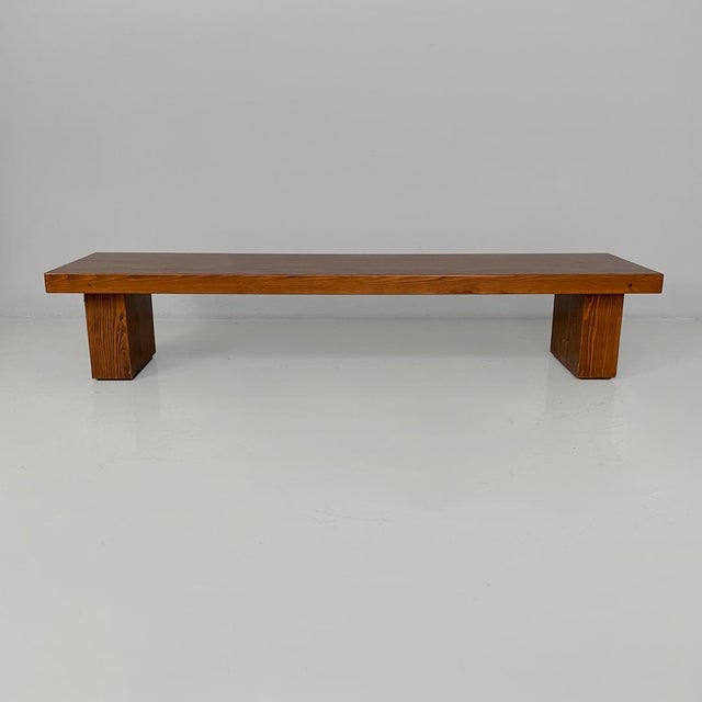 Italian modern wooden bench, 1970s Bench made entirely of solid wood with a warm finish. The top is long and thick, with...
