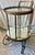 This brass bar cart with glass shelves and mirrored bottom has a wonderfully simple art deco style and is of fantastic...