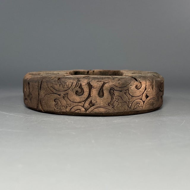 This antique Chinese circular ceramic piece is crafted from fired clay, with exquisite carved patterns on the surface. It...
