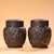 This is a matching pair of silver-plated tea caddies or covered jars, featuring elaborate high-relief (repoussé)...