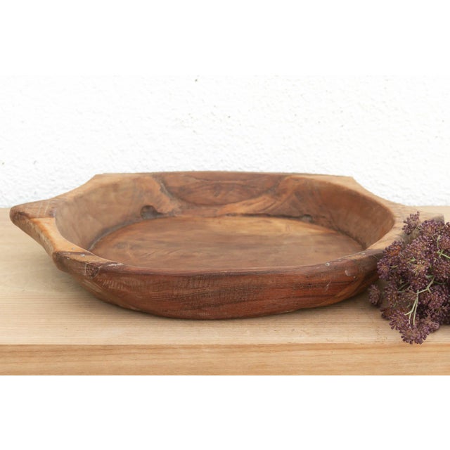 The sculptural form of this vintage bowl takes center stage. Carved from a single piece of solid hardwood, it features a...