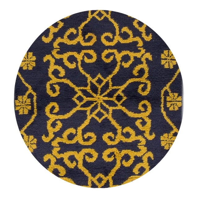 A vintage hand-knotted Chinese rug with an allover design on a blue field with yellow accents. This rug has magnificent...
