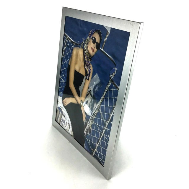Brushed aluminum with glass will hold your favorite photo and show off your cool modern taste. Simple and elegant. A few...