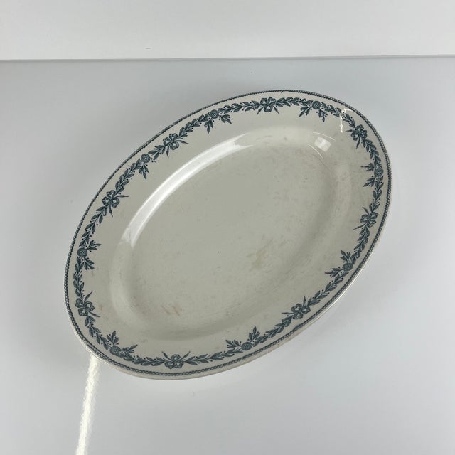 Large oval ironstone platter, "Laurels" pattern, by Moulins des Loups - Hamage, 1900 Dimensions: 34 x 23.5 cm Height: 4 cm...