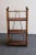 Petite antique three-tiered etagere/bookcase/shelving unit (ca. early 20th Century, USA). Composed of a bamboo frame with...