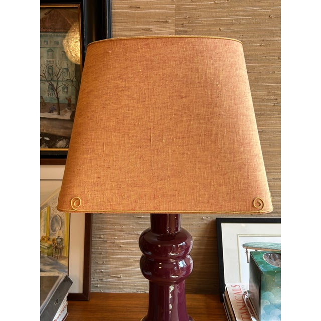 Custom lampshade out of an orange ochre linen fabric with a contrast yellow trim along the top and bottom. Oval top with...