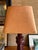 Custom lampshade out of an orange ochre linen fabric with a contrast yellow trim along the top and bottom. Oval top with...