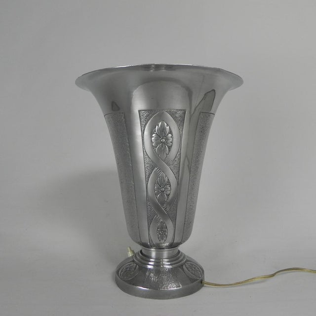 Art deco table lamp from the 1930s, made of aluminum. the shade features characteristic geometric decorations typical of...