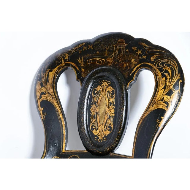 English C.1860, pair of black papier mache chairs with cabriole legs, cane seats and exuberant gold painted decoration.