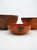 This image features a graduated set of three vintage Hanova of Pasadena enameled bowls, showcasing the iconic mid-century...