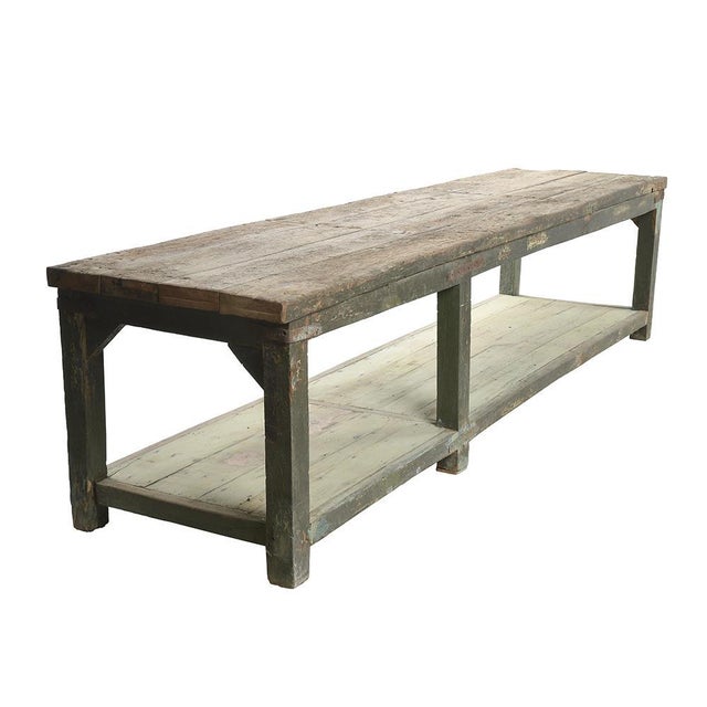 Former old patinated teak workshop table. This piece is designed in the style of the selected designer and/or manufacturer