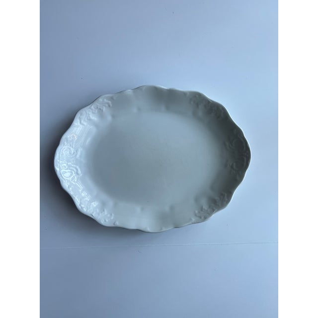 Embossed ironstone platter, all white, leaf and scroll patterned border. Marked Johnson Bros - Royal Ironstone China....