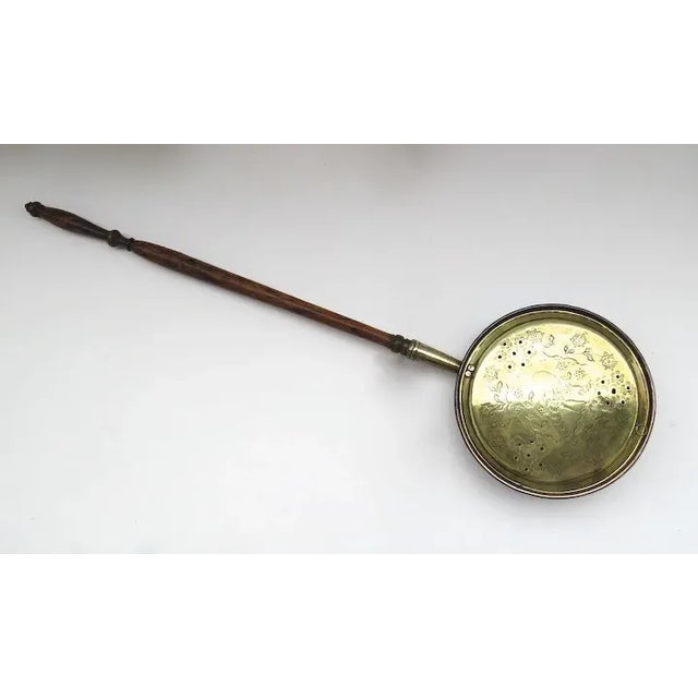 Brass bed warmer with nicely turned handle. Decorated and pierced lid. 19th century Dimensions: 12" diameter 43 1/2" long...