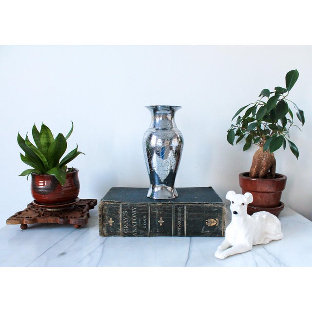 Chinese export silver tone brass vase, dating from the late 19th or early 20th century. The vase features detailed, etched...