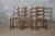 An elegant set of three 1950s French ladder-back dining chairs, expertly crafted from solid oak with hand-woven rush...