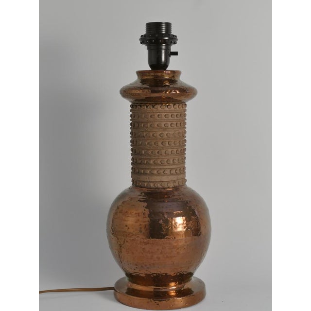 Mid-century Modern Copper-hued Ceramic Table Lamp by Bitossi for Bergboms, 1970s This is a striking table lamp crafted by...