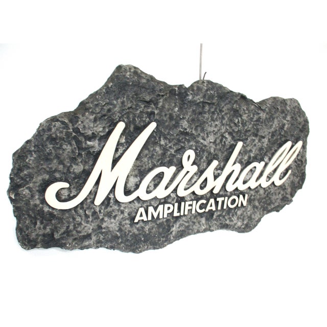 A vintage advertising sign for the Marshall Amplification company used in retail and wholesale stereo, guitar and rock and...