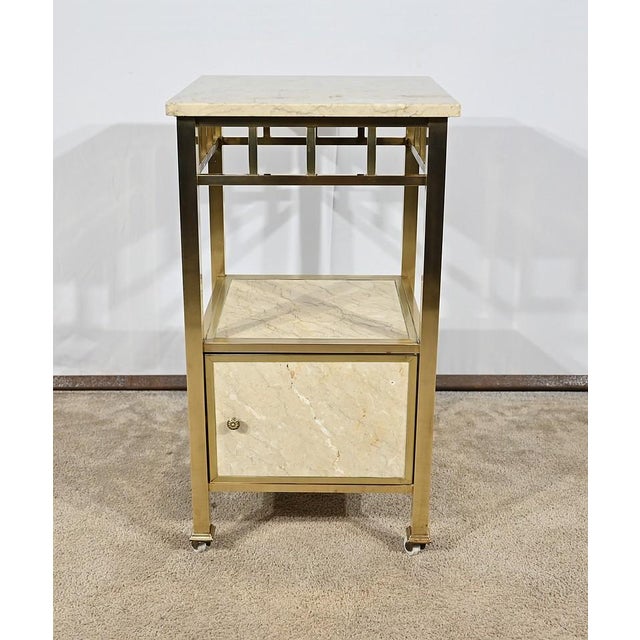 Furniture all -side facing a brass frame, made up of squares of square section forming feet and ending with moldings...