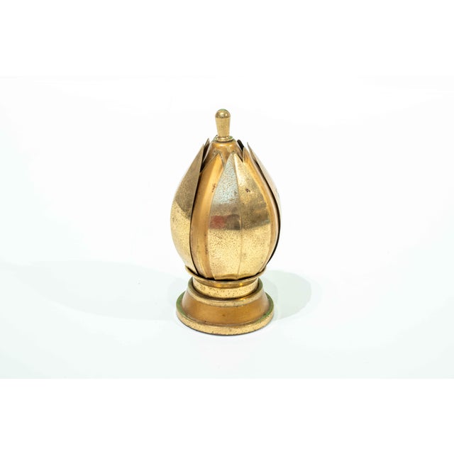 This item is a rare cigarette dispenser from the Mid-Century era. The lotus blossom shape is made entirely of brass. When...