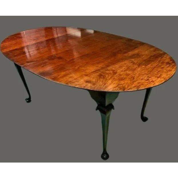 Featured is a Reproduction Queen Anne Style Solid Cherry Dining Table by D. R. Dimes Benchmark Collection. This Queen Anne...