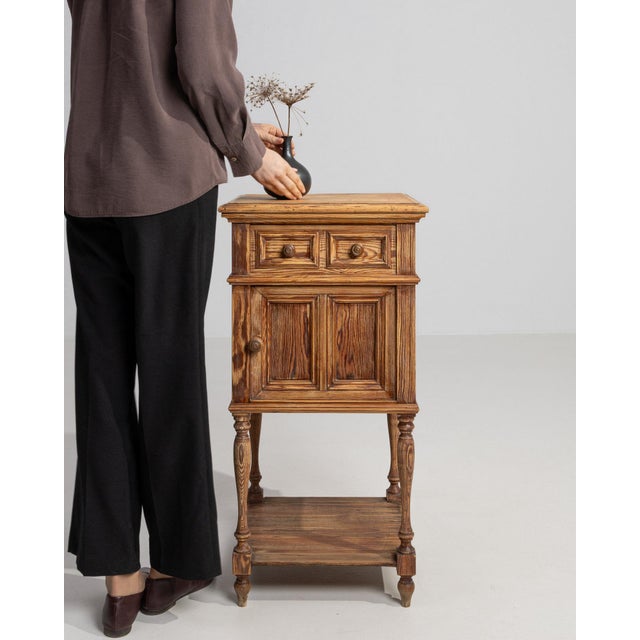 Carved oak bedside cabinet in Golden Oak. The golden oak surface highlights two drawers, fluted pilasters, turned feet,...