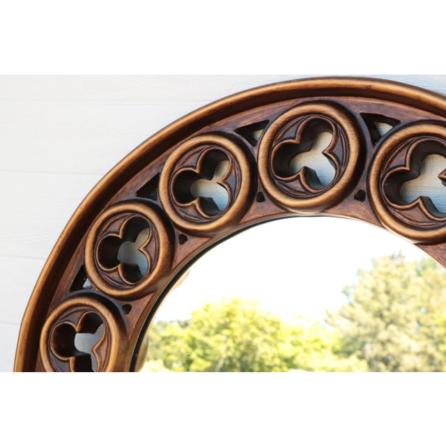 Vintage sculpted mirror with a burnished gold painted finish. The 2" deep circular frame surrounds a mirror measuring 19...