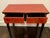 A Chinese altar table, desk or console in lacquered wood with a striking and heavily distressed finish in a red and black...