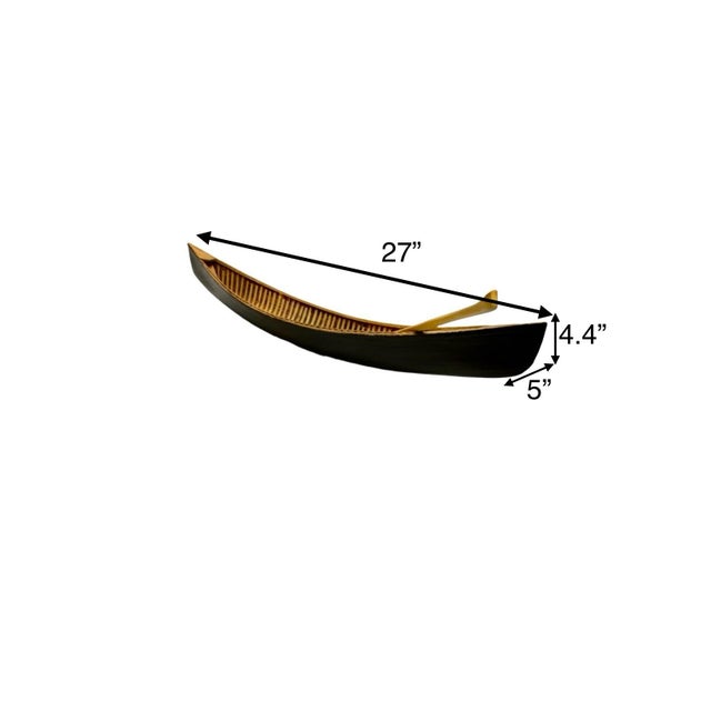 This vintage canoe model with a paddle, designed in a large wood rowboat style, serves as a unique and charming piece of...