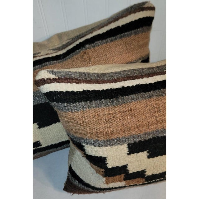 Pair of hand made Mexican wool Saddle blanket weaving pillows with linen backing.The inserts are down & feather fill.
