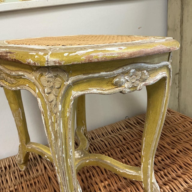 Lovely antique wood French footstool. We replaced the cane as original was damaged. The stool features carvings on the...