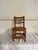 Bamboo ladder back child's chair. The chair has a three-slat ladder back and a square seat design. Visible wear and patina...