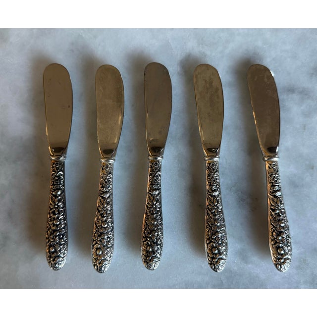 Set of 5 silver plated butter knives with floral Victorian Revival pattern on the handles. Made by Godinger for the...