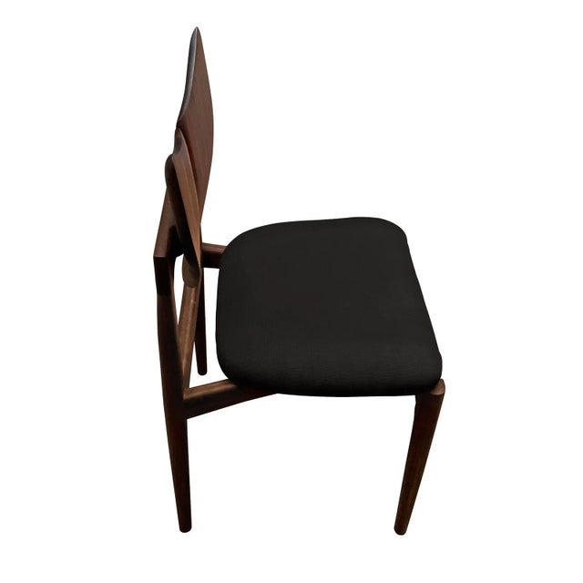 Mid century style solid walnut dining chairs. The chairs are is the style of Kurt Ostervig butterfly iconic butterfly...