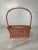 Antique rectangle shaped wicker Easter basket with wood bottom and arched twisted wicker handle. Finished with pink and...