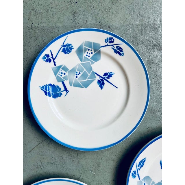 with their pretty stylized Art Deco blue flowers and border, these plates from the Keller et Guerin pottery in Lunéville...