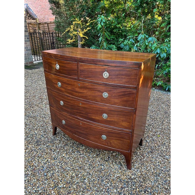 19th Century Georgian Mahogany Bow Fronted Chest of Drawers, with two short and three long graduated oak lined drawers...
