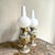 This pair of hand-painted porcelain table lamps was crafted in portugal by the renowned alcobaça porcelain factory...
