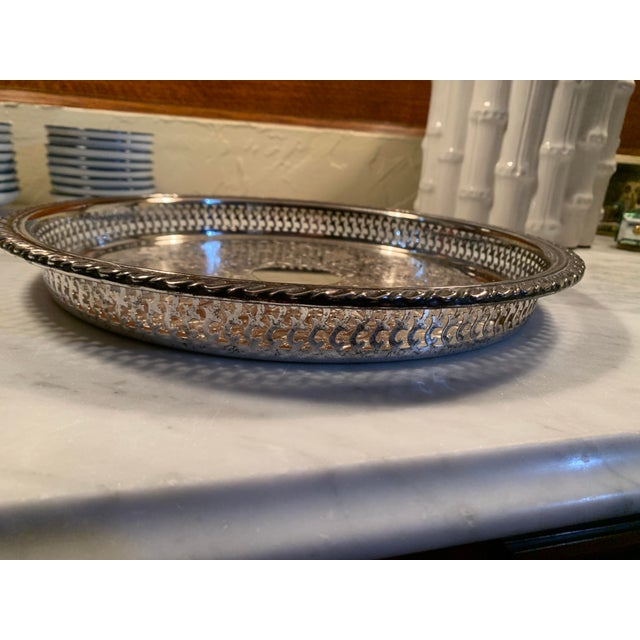 Here we have a very pretty round silver-plated tray. This one is made in America by Oneida with lovely chased center...