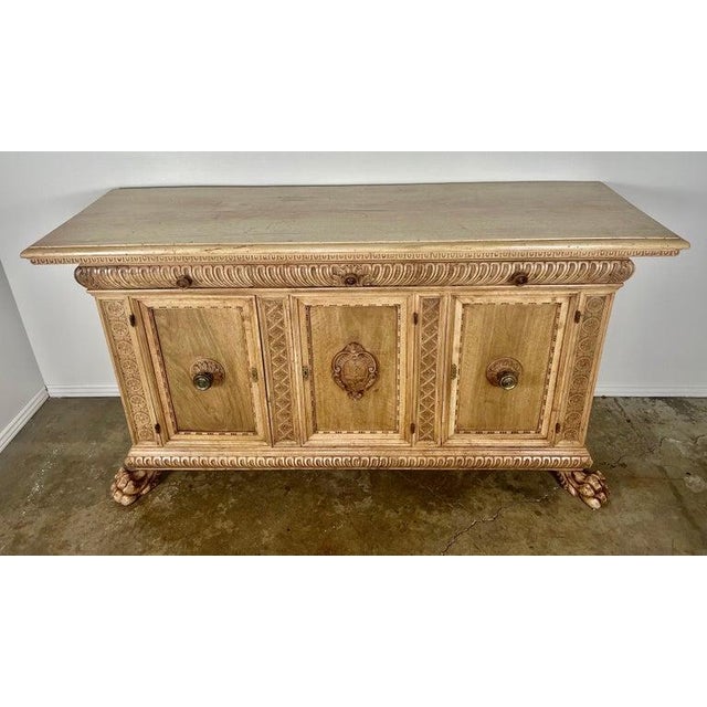 Early 19th century French Provincial carved credenza. The credenza has two working doors and three drawers for plenty of...