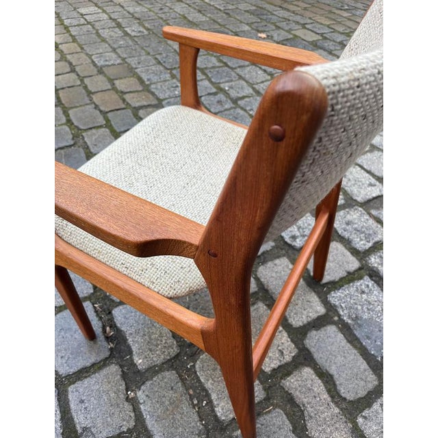 The armchair by Erik Buch for Nova Møbler exemplifies Danish mid-century design from the 1960s. It features a solid frame...