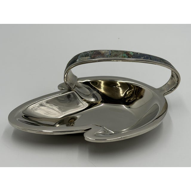 A striking example of mid-century Mexican Modernist metalwork, this sculptural Los Castillo catchall dish was designed and...