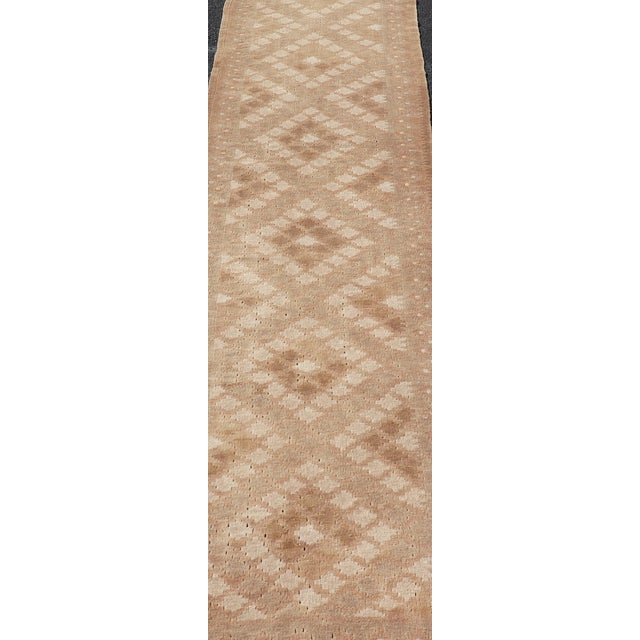 Measures: 2'5 x 12'0 This beautiful vintage Turkish Tribal Kilim runner showcases a rich tapestry of warm earth tones and...