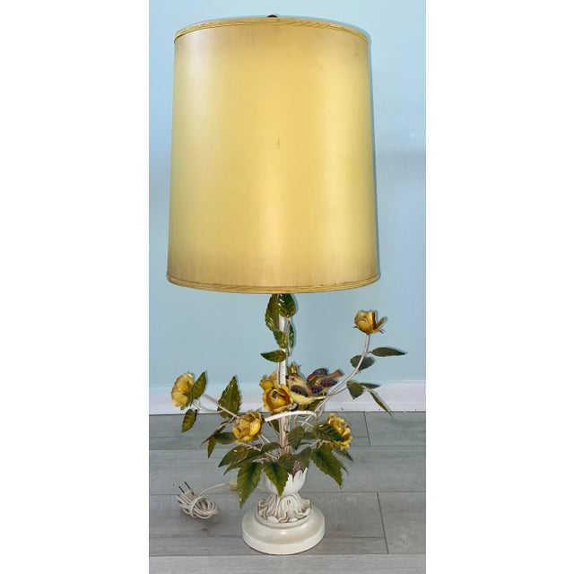 Charming vintage tole table lamp with yellow roses and birds. Measures 33” to the top of the finial x about 15” wide.