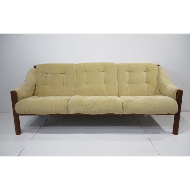 A very comfortable sofa with soft corduroy styled chenille button cushion upholstery sitting on a sturdy solid teak wood...