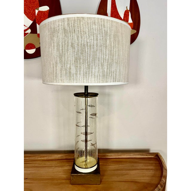 Offered are a pair of fun American cylinder lamps. The raised, textured design depicts fish swimming through the sea with...